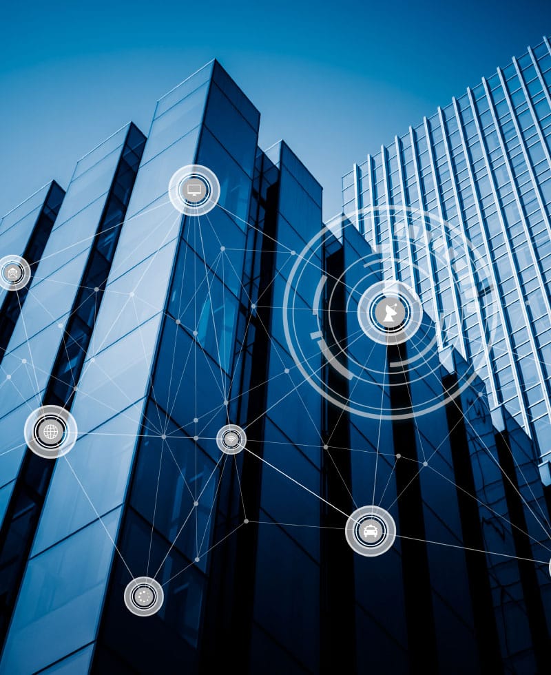 Modern glass buildings with digital network icons overlaid, symbolizing smart building technology